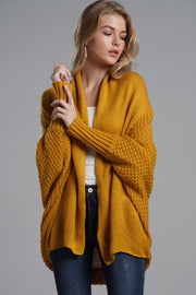 Mustard knit cardigan with drape front, batwing sleeves and textured detail.