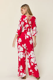 Red floral kimono jumpsuit with tie back and wide legs