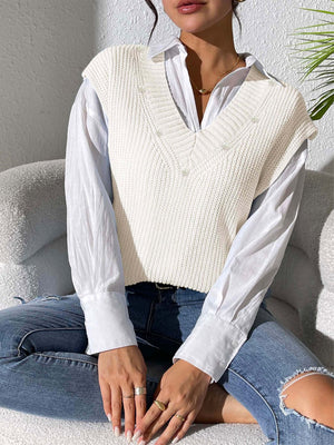Ivory ribbed knit sleeveless V-neck vest with pearl embellishments.