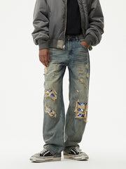 Distressed blue plaid patch wide leg jeans with ripped details.