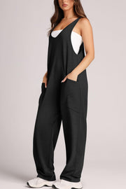 Black relaxed fit jumpsuit with oversized pockets, V-neck, sleeveless, and wide legs.
