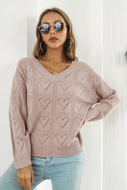 Dusty Pink V-neck knit pullover sweater with allover heart pattern and long sleeves.