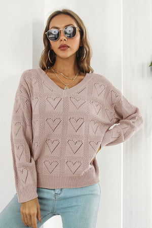 Dusty Pink V-neck knit pullover sweater with allover heart pattern and long sleeves.