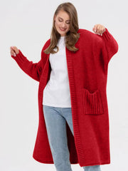 Oversized red acrylic knit cocoon cardigan with pockets and ribbed details.