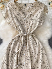 Apricot polka dot maxi dress with button front and tie belt.