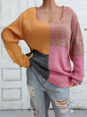 Colorblock knit sweater with button cuffs in sherbet, pink, orange, and grey.