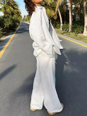 Relaxed fit white linen two-piece set with wide-leg pants and a button-up shirt.