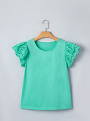 Eyelet lace ruffled cap sleeve top in green with a round neckline.