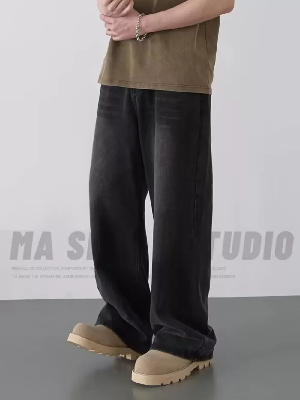 Men's oversized dark wash jeans in black gray, styled casually.