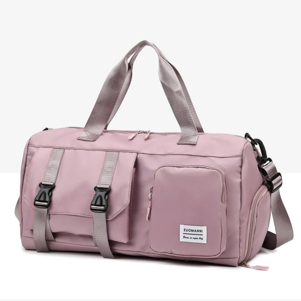 Dusty Pink duffel bag with buckle details and multiple pockets.