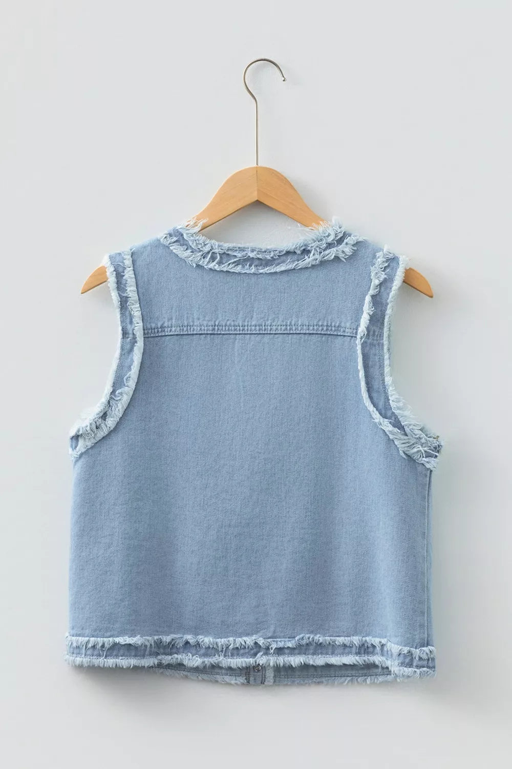 Light wash denim vest with frayed edges and collar detail.