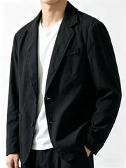 Black long sleeve blazer with notched lapels and two-button closure, styled with a white t-shirt.