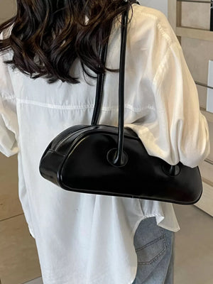 Black pu leather shoulder bag with minimalist design and zipper closure.