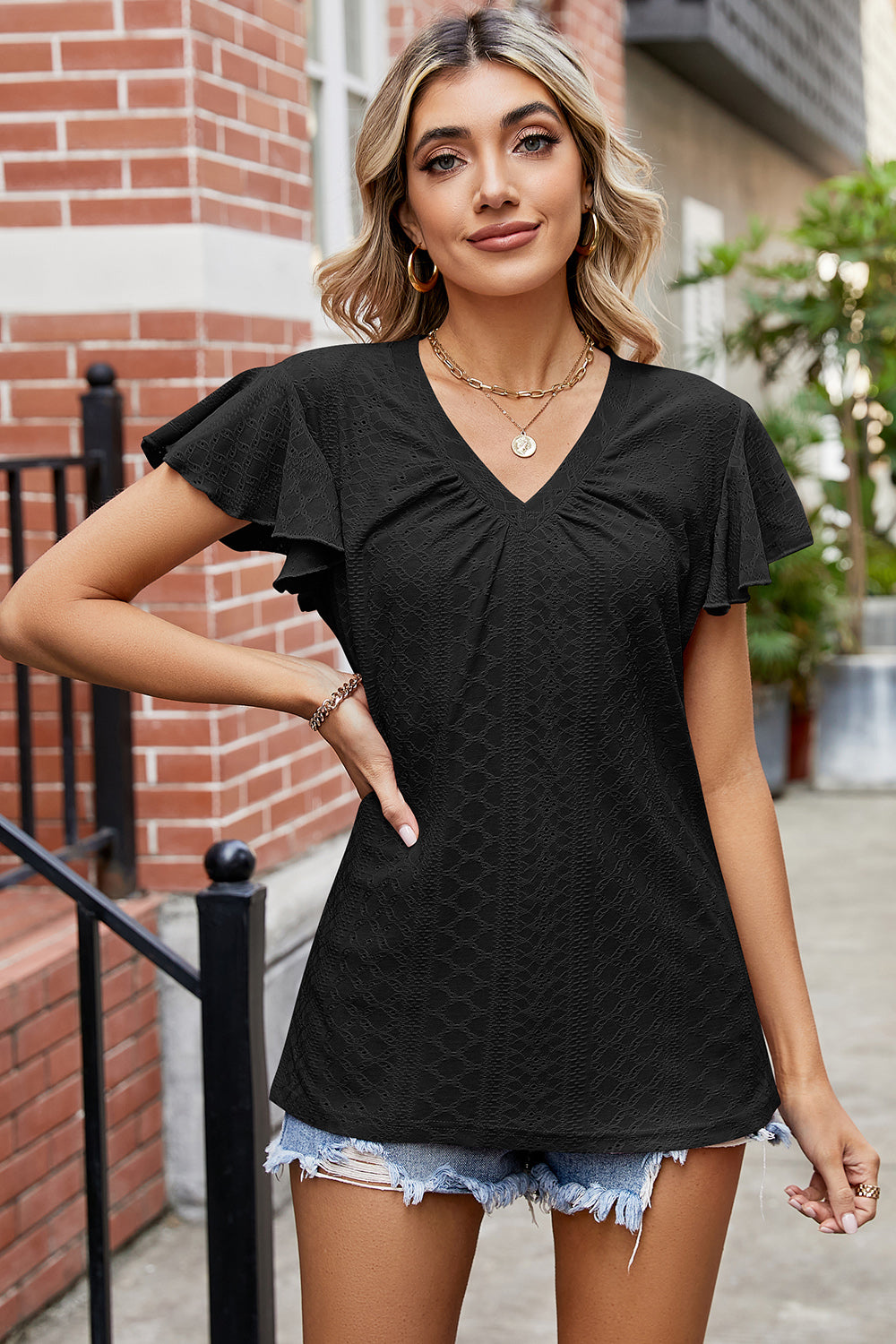 Black eyelet flutter sleeve v-neck top with ruched detail