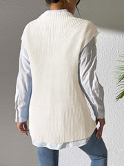 Ivory ribbed knit sleeveless vest over a light blue collared shirt.