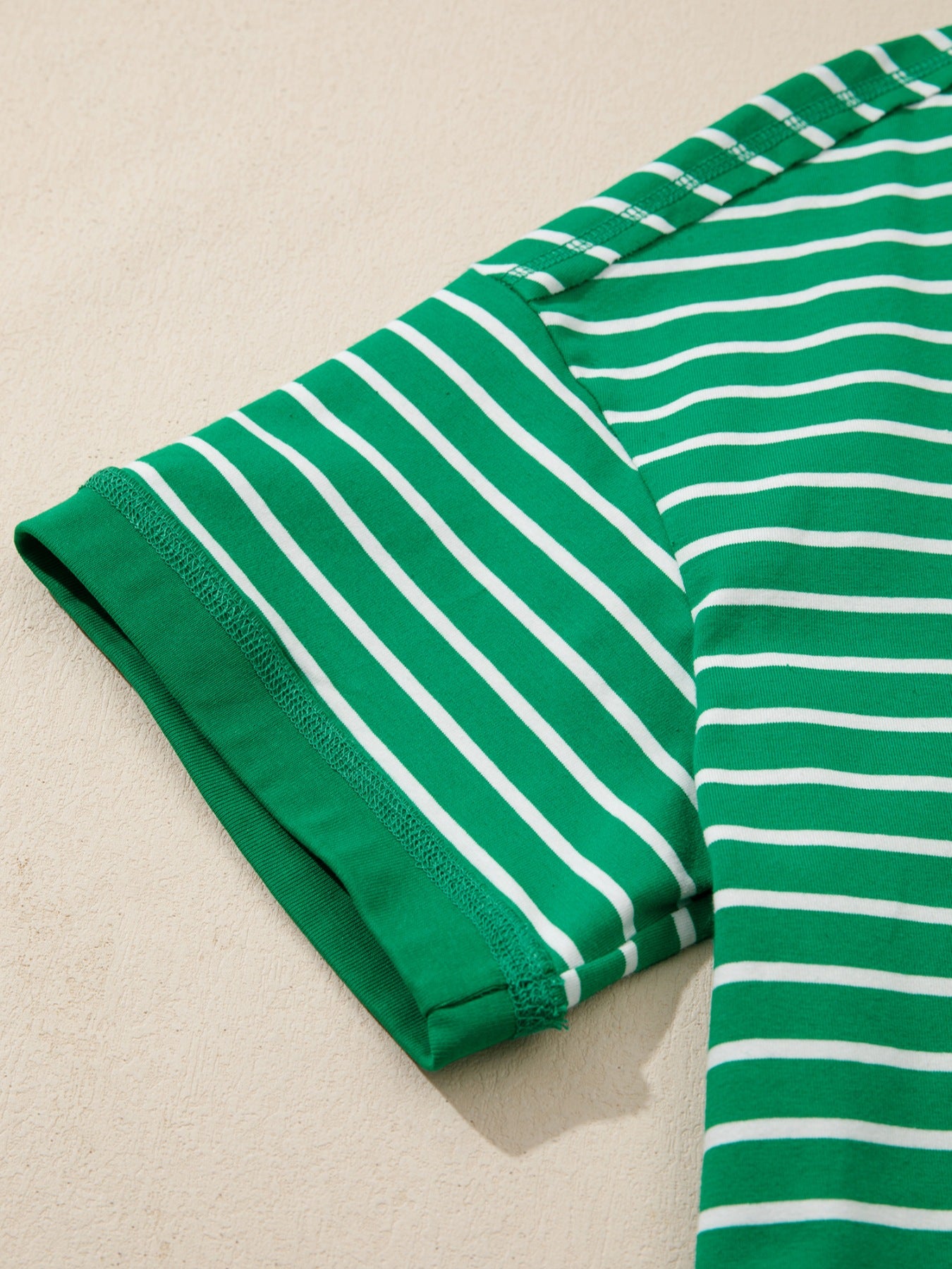 Green and white striped cotton t-shirt with crew neck and short sleeves.