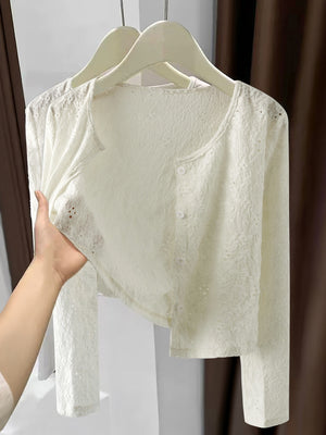 White lace button-up cardigan with delicate eyelet details and a cropped length.