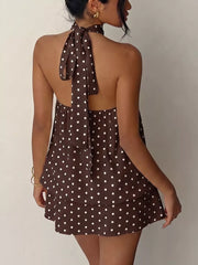 Coffee brown polka dot halter mini dress with a tie-back detail.