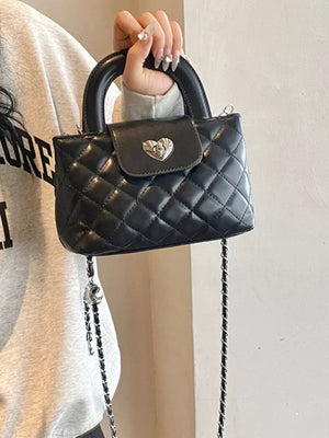 Quilted Heart Lock Crossbody Bag in Black, model styling view