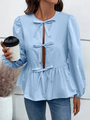 Light blue peplum blouse with keyhole neckline and tie details