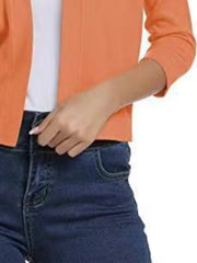 Cropped elbow-sleeve open-front knit cardigan in Sherbet orange, styled with dark wash jeans.