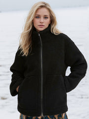 Black sherpa jacket with stand collar and zip front, featuring side pockets.
