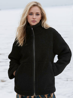 Black sherpa jacket with stand collar and zip front, featuring side pockets.