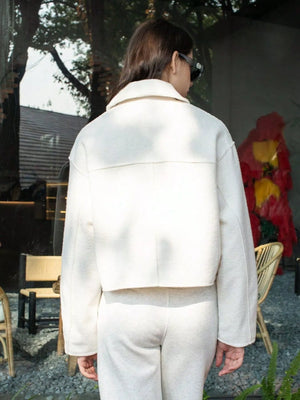 White cropped zip-up jacket with collar and pockets, shown from the back.