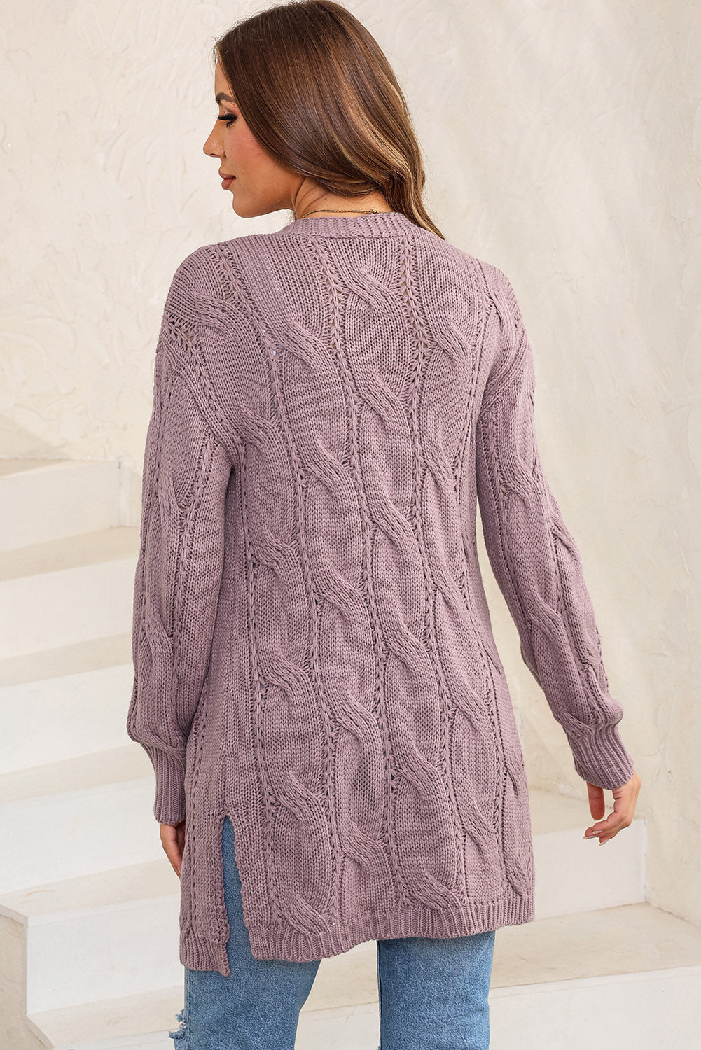 Lilac cable knit long cardigan with open front and side slits.