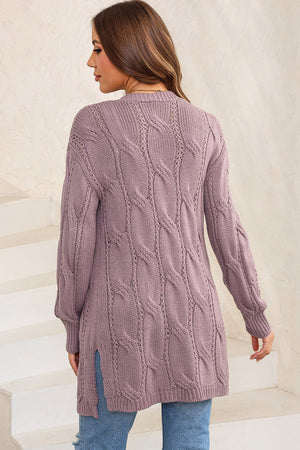 Lilac cable knit long cardigan with open front and side slits.