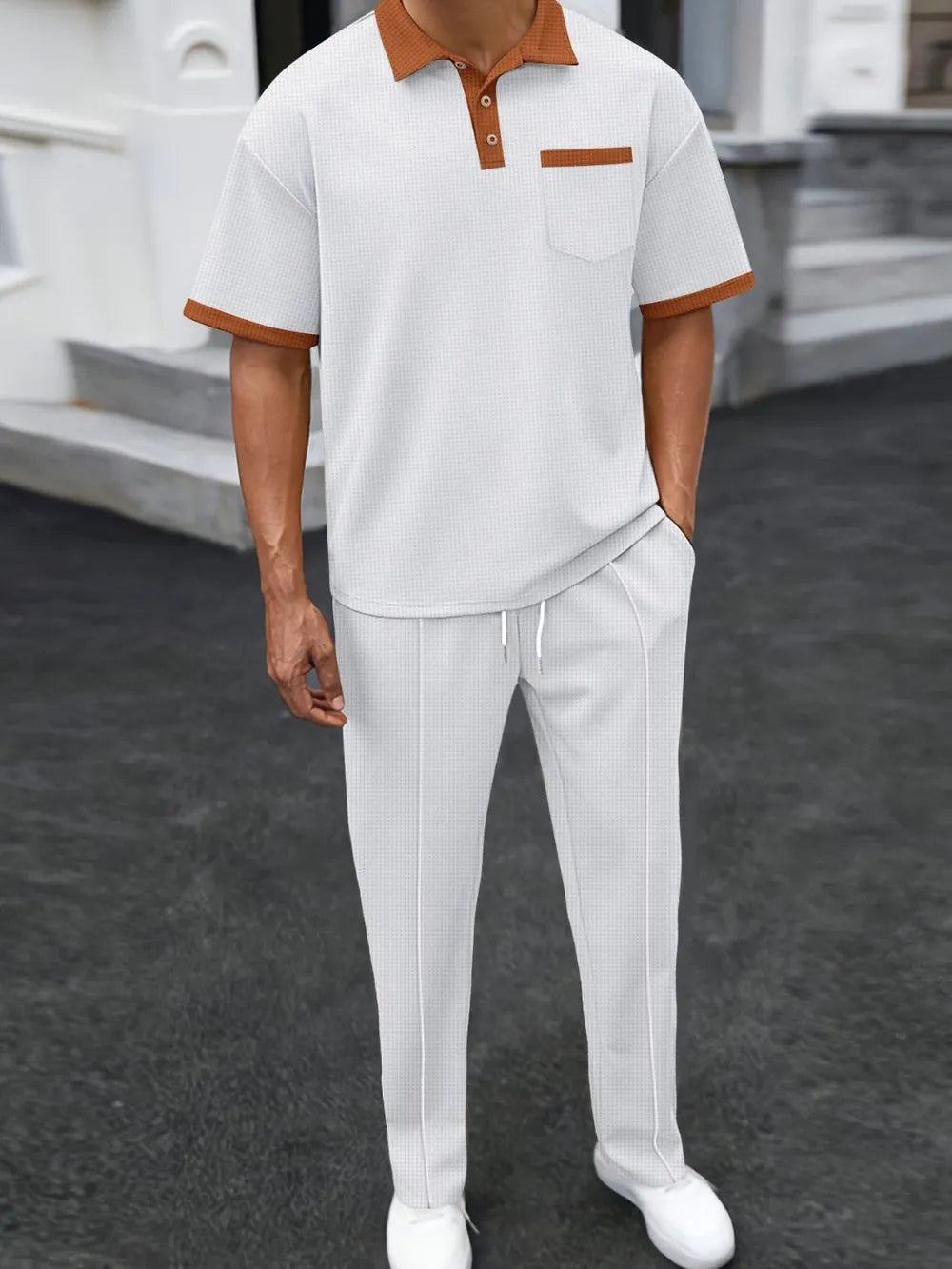 White textured polo shirt with contrast collar and pocket, paired with matching track pants.