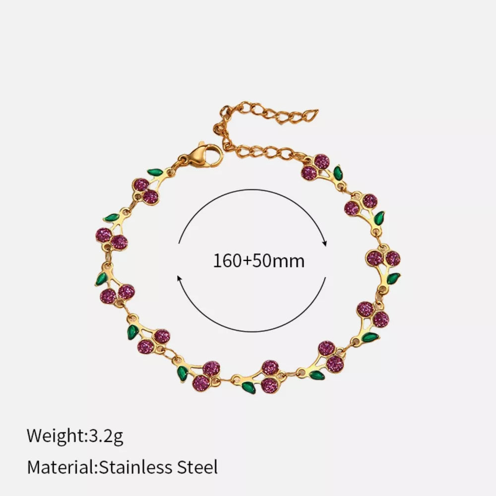Gold-plated bracelet with pink cherry clusters and green leaves, adjustable length.
