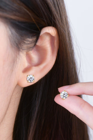 Gold moissanite solitaire stud earrings with brilliant cut stone.