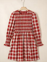 Red plaid cotton mini dress with smocked bodice, puff sleeves, and ruffled cuffs.
