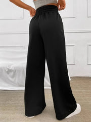 Black wide-leg sweatpants with a drawstring waist and elastic waistband.
