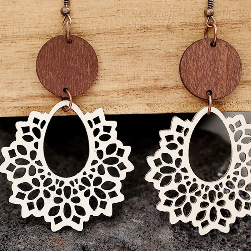 Floral laser-cut wooden drop earrings with ivory lace detail and tan wood circles.