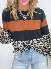 Leopard print patchwork blouse with orange and black stripes, long sleeves, and crew neck.