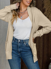 Tan textured knit open-front cardigan with pockets, styled with a white tank and jeans.