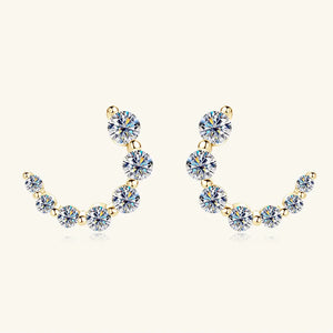 Gold Celestial Arc Moissanite Earrings with a curved row of sparkling stones and 18K gold plating.