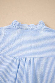 Blue and white striped cotton shirt with ruffle neckline and gathered waist.