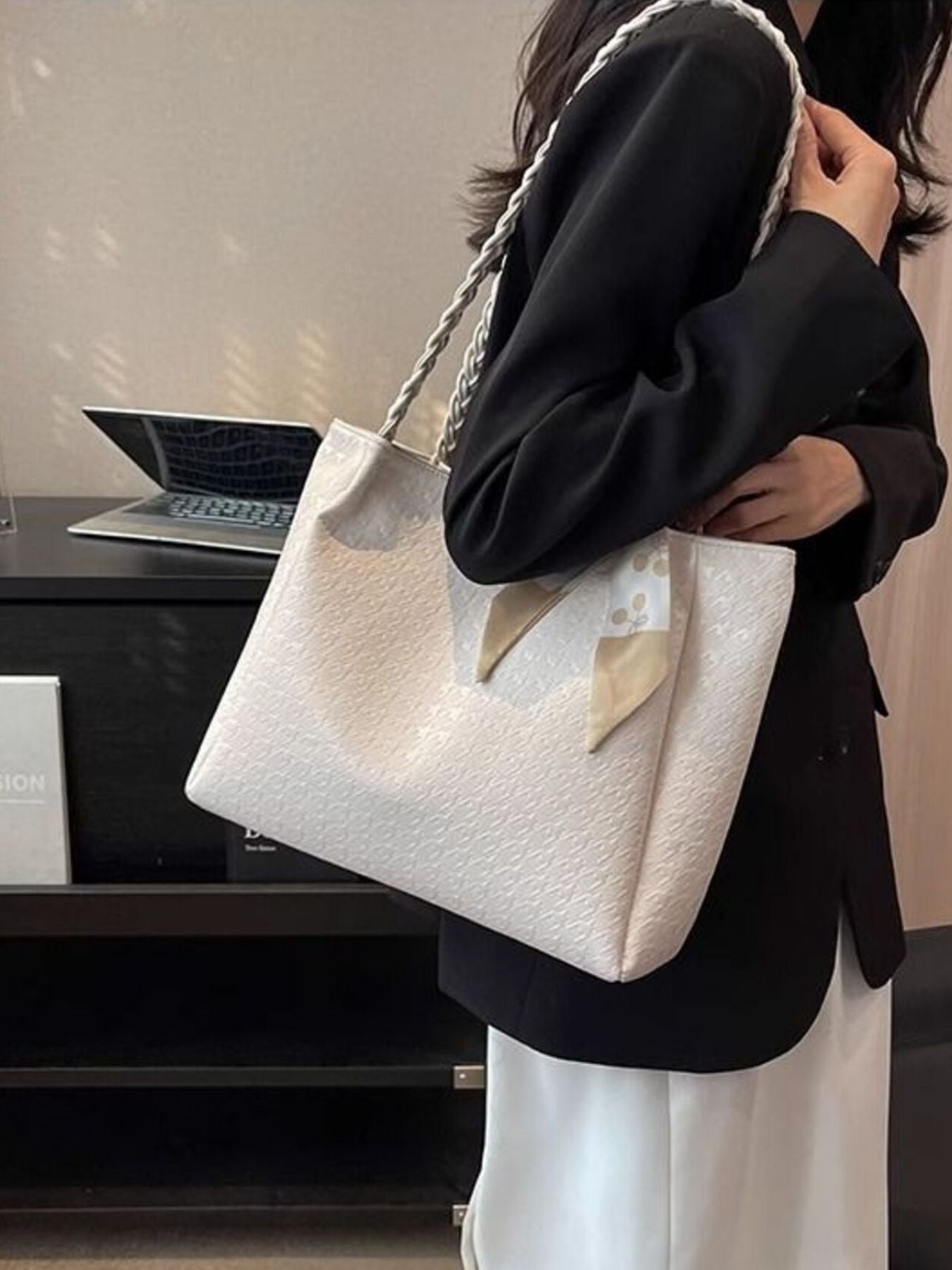 Elegant ivory tote bag with braided handles and a charming scarf detail.