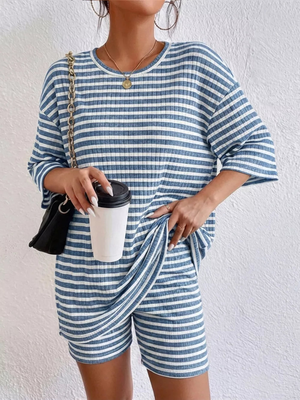 Blue striped two-piece set with elbow sleeves and shorts, ribbed fabric.