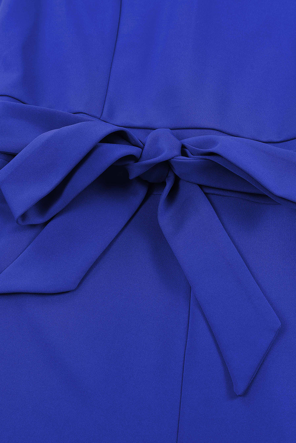 Royal blue tie-waist jumpsuit with a bow detail at the waist.