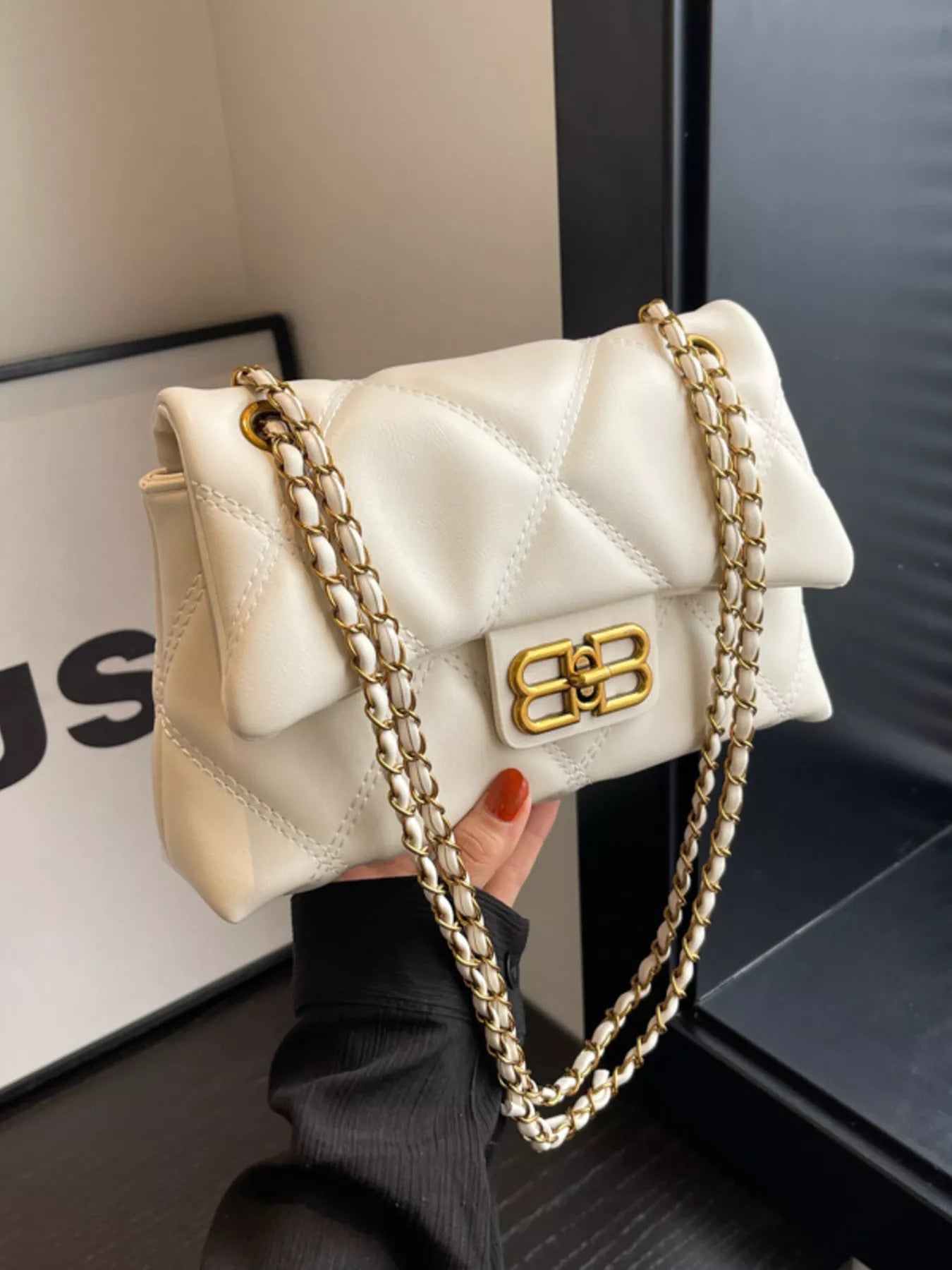 White quilted flap shoulder bag with gold chain strap and logo clasp