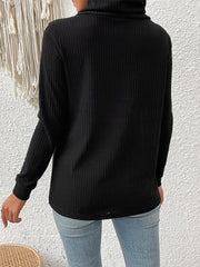 Black ribbed turtleneck sweater with asymmetric button detail