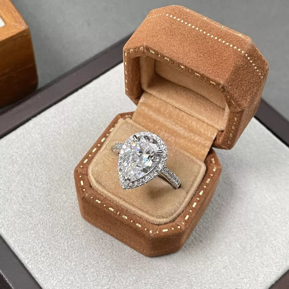 Elegant moissanite teardrop ring in sterling silver with halo setting