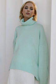 Oversized pastel blue cashmere turtleneck sweater with ribbed cuffs and hem.