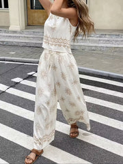 White two-piece set with medallion print, sleeveless crop top and wide-leg drawstring pants.