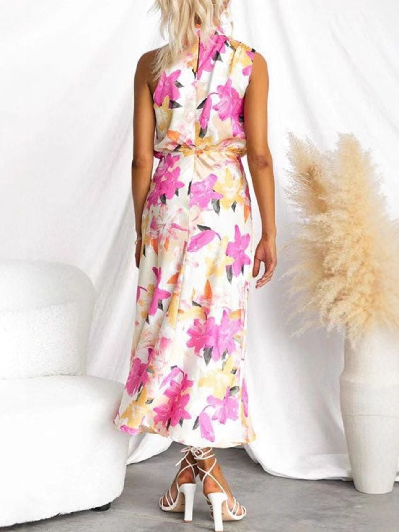 Vibrant floral midi dress with high neck and cinched waist, back view.