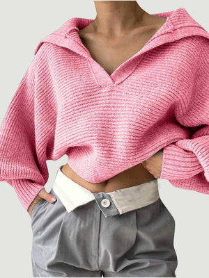 Pink knit sweater with wide collar and balloon sleeves, ribbed texture, V-neck.